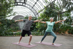 an older couple does yoga in a peaceful greenhouse – Amazing Home Care